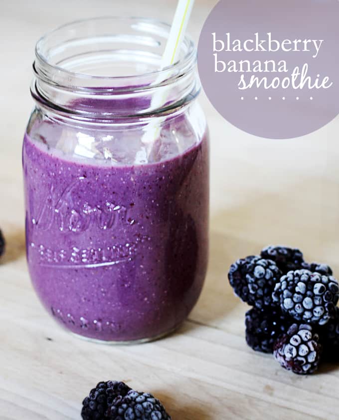 blackberry banana smoothie in mason jar with blackberries on the table.