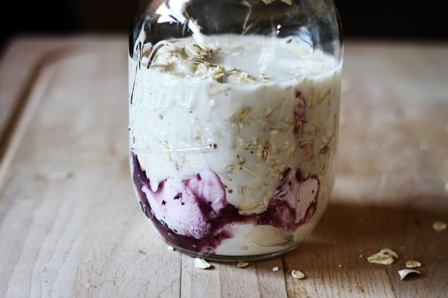 blueberry muffin overnight oats with milk in mason jar.