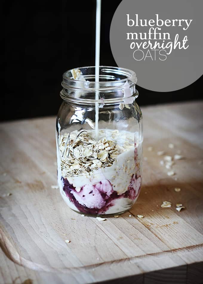 blueberry muffin overnight oats in mason jar with milk being poured into mason jar.