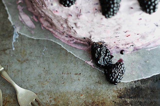 blackberry lime cake on baking sheet with fork.