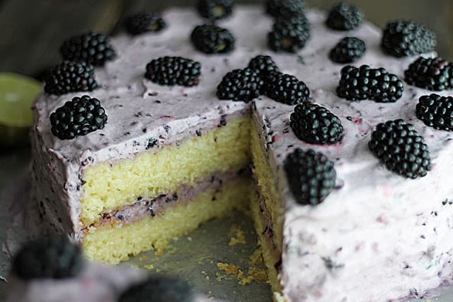 blackberry lime cake with slices gone. 