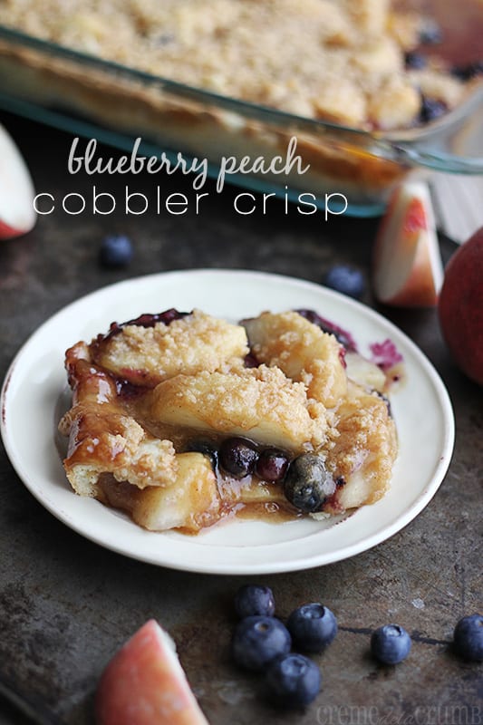 blueberry peach cobbler crisp slice on small white plate.