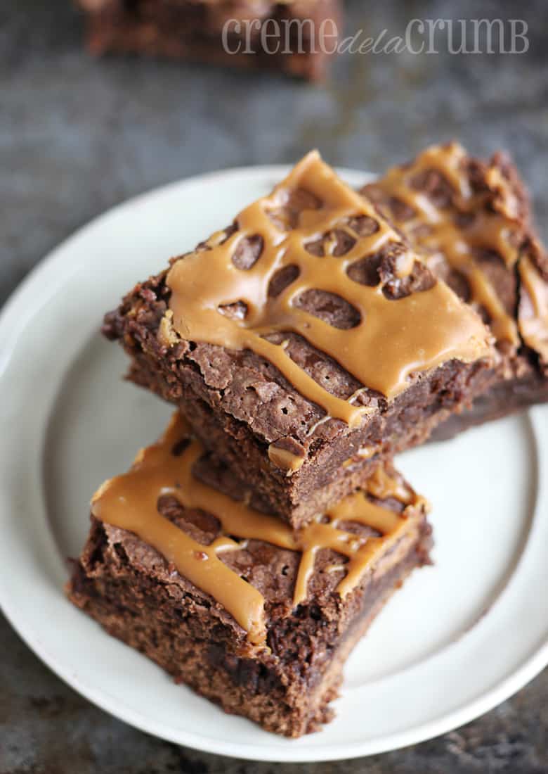 top view of three stacked brownies on a plate.