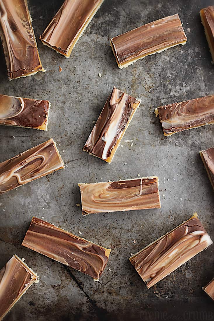 top view of chocolate caramel shortbread bars on a baking sheet.