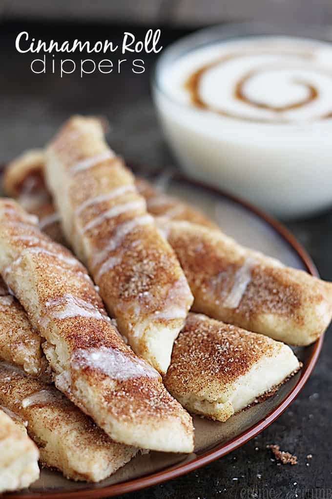 cinnamon roll dippers on a plate with glaze dip in a bowl faded in the background with the title written on the top left corner of the image.