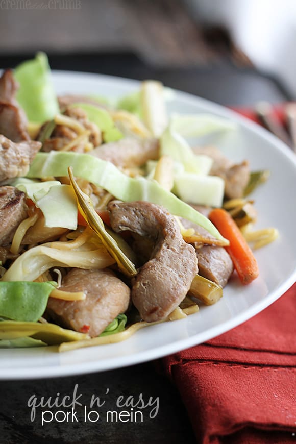 pork lo mein on a plate with the title written on the bottom left corner of the image.
