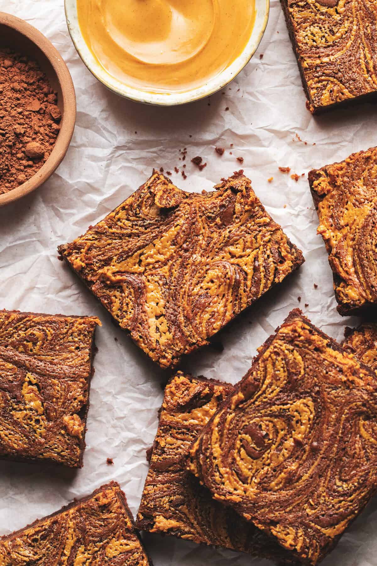 brownies with peanut butter swirl on parchment.