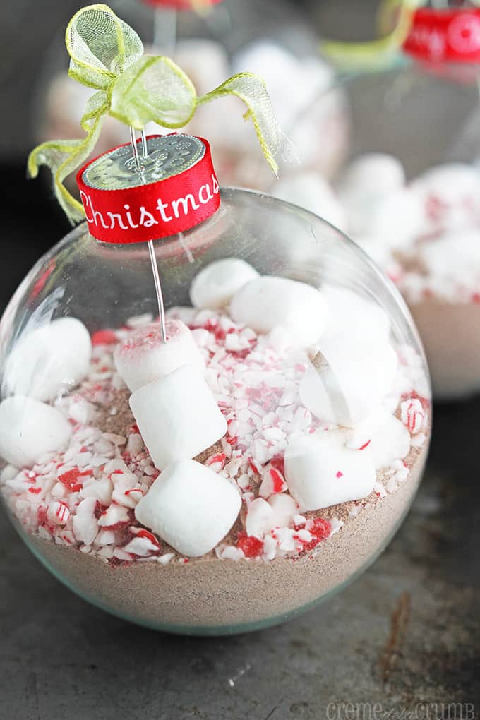 peppermint cocoa Christmas ornament with more ornaments faded in the background.