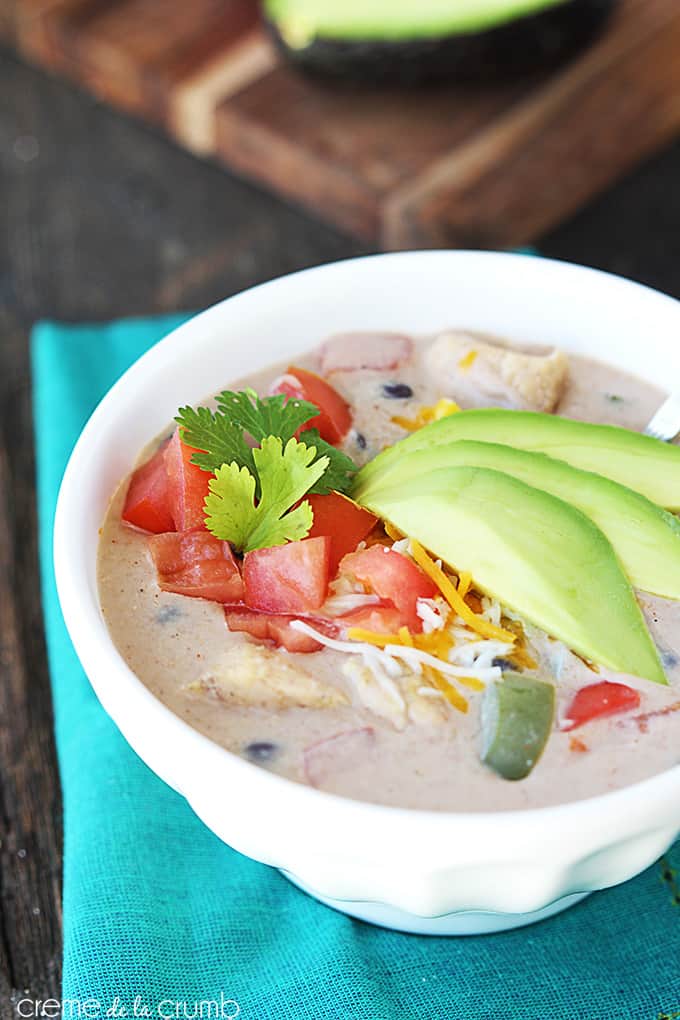 chicken fajita soup in a bowl on a blue cloth napkin.