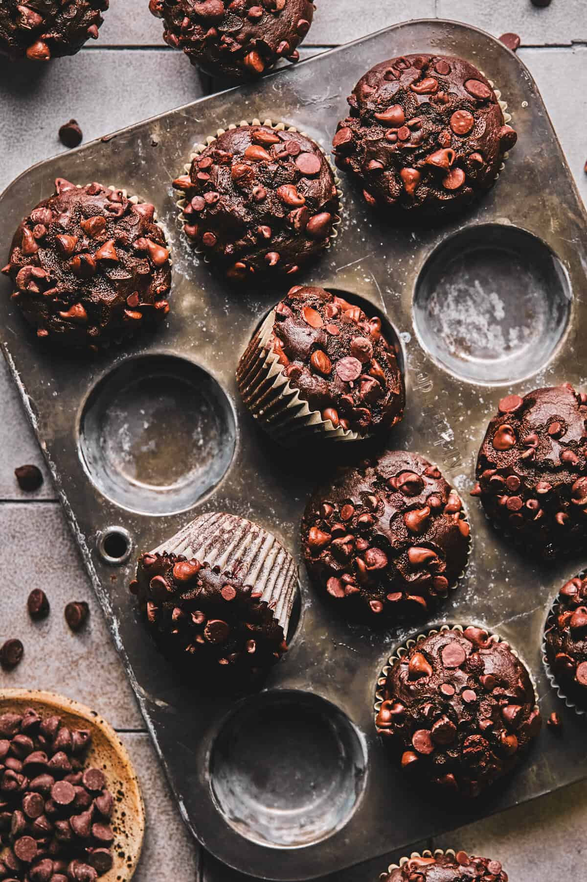 Overhead of chocolate muffins in a muffin tin.