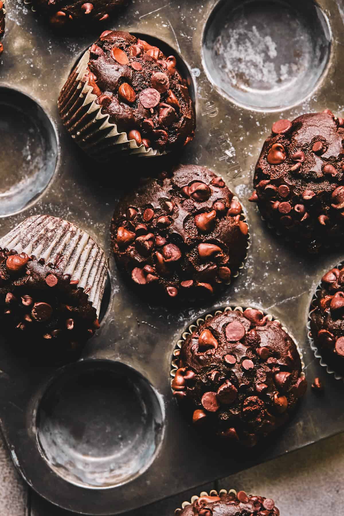 Close up overhead of chocolate muffins in a muffin tin.