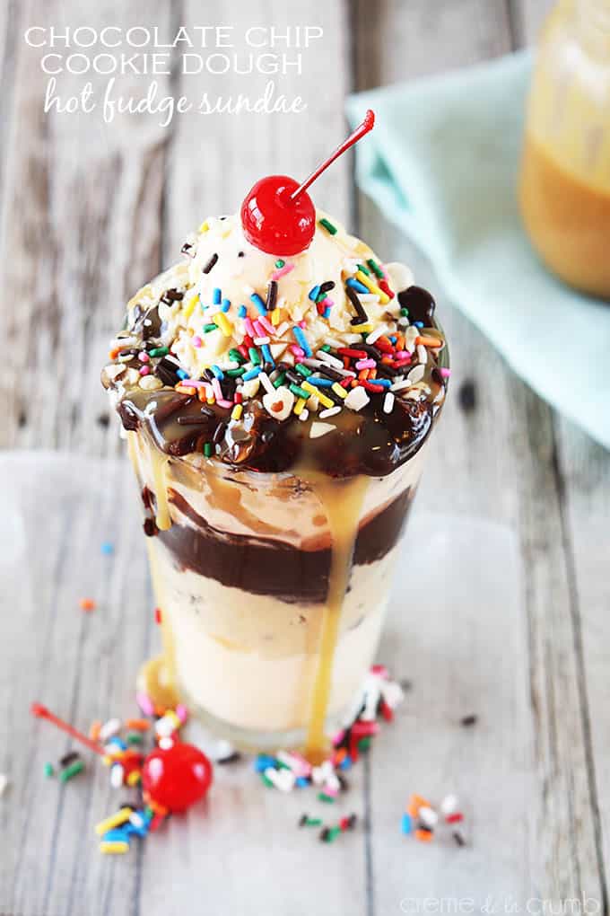 chocolate chip cookie dough hot fudge sundae topped with a cherry in a tall glass with the title of the recipe written on the top left corner of the image.