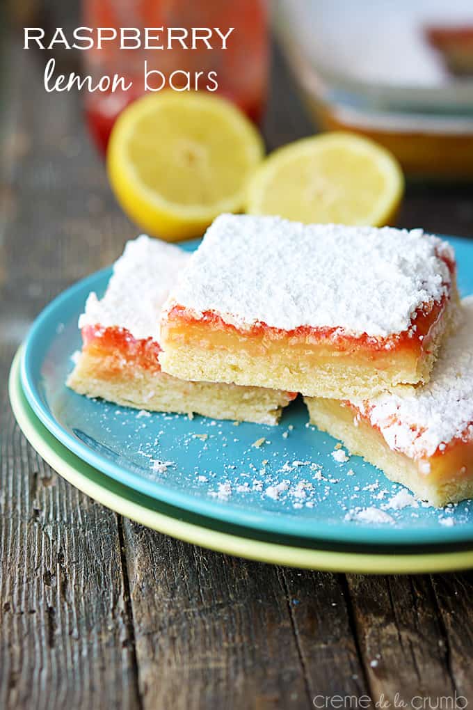 raspberry lemon bars on a plate with the title of the recipe written on the top left corner of the image.