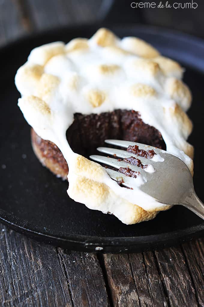 S'mores lava cake in a skillet with a fork taking a bite out of it.