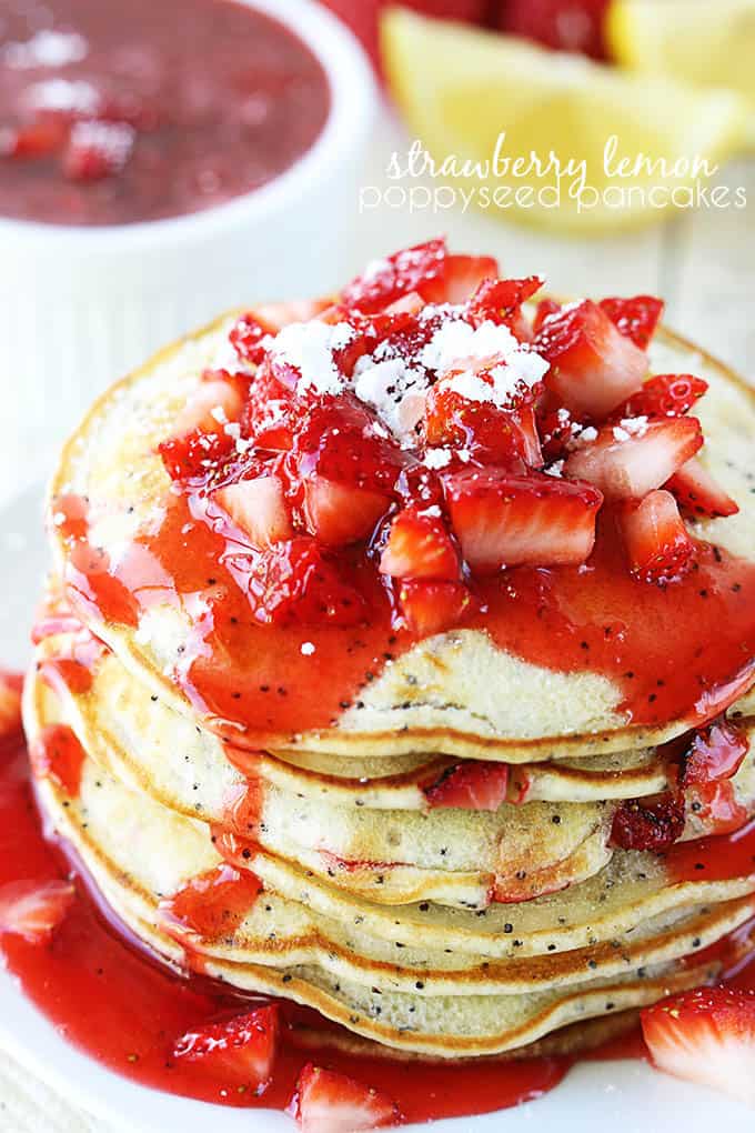 strawberry lemon poppyseed pancakes with strawberry sauce and strawberries on top with the title of the recipe written on the top right corner of the image.