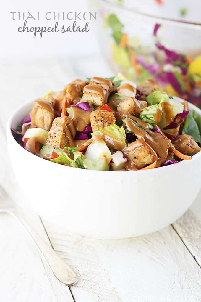 Thai chicken chopped salad in a bowl with the title of the recipe written on the top left corner of the image.