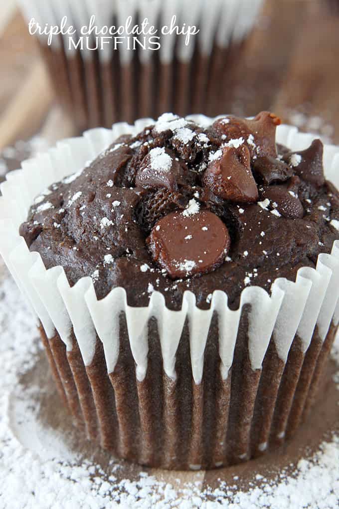 a triple chocolate chip muffin with the title of the recipe written on the top left corner of the image.