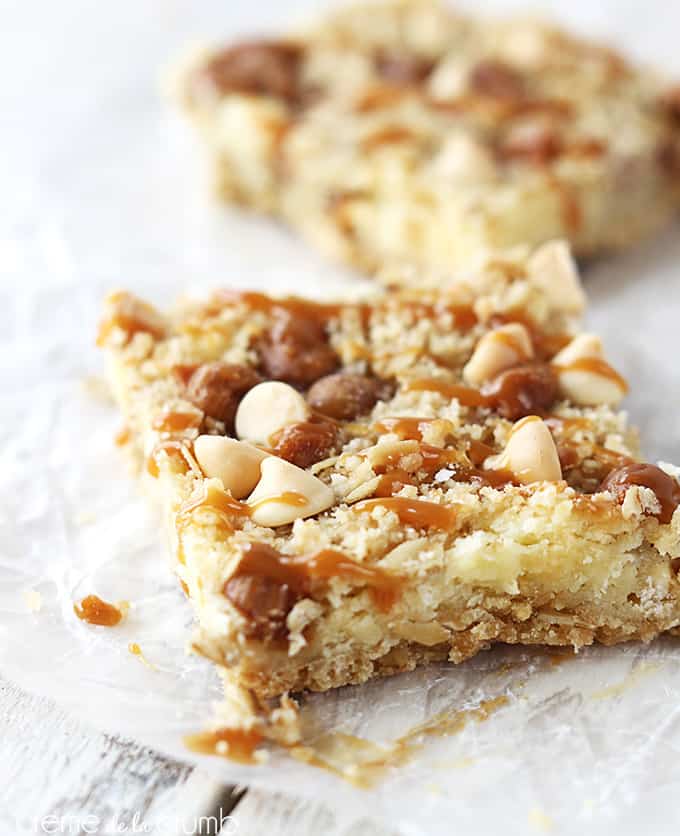 a caramel crumble cheesecake bar with another bar faded in the background.