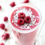 Top view of raspberry coconut smoothie in a cup.