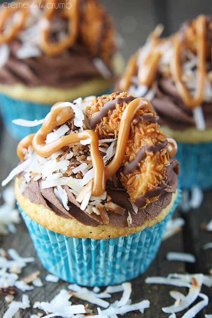 a Samoas cupcake with more cupcakes faded in the background.