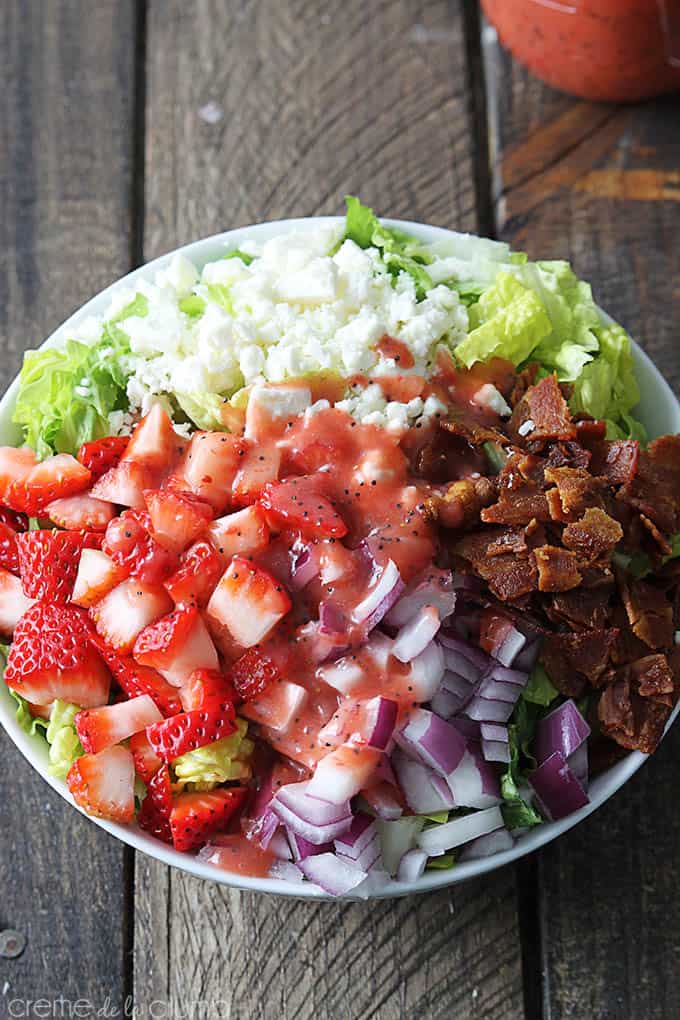 top view of strawberry poppyseed & bacon chopped salad in a bowl.