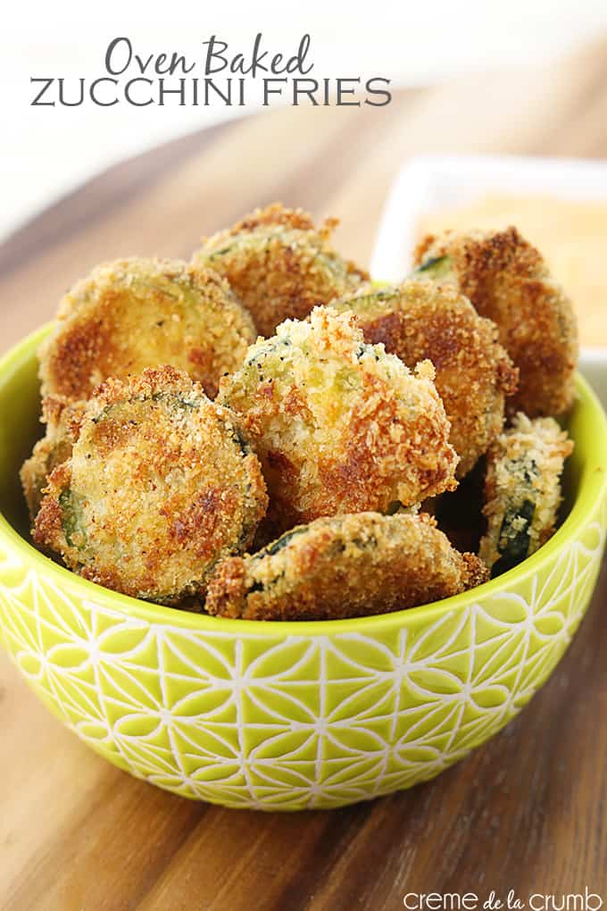 oven baked zucchini fries in a bowl with dipping sauce faded in the background with title of the recipe written on the top left corner of the image.
