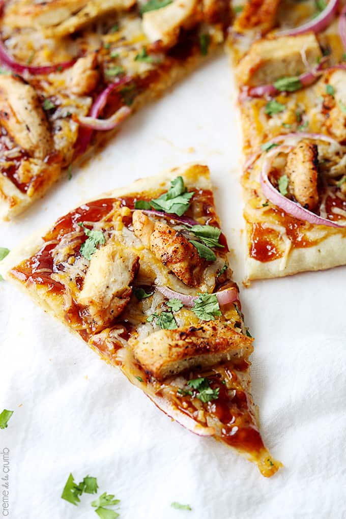 a slice of bbq chicken flatbread pizza next to the entire pizza.