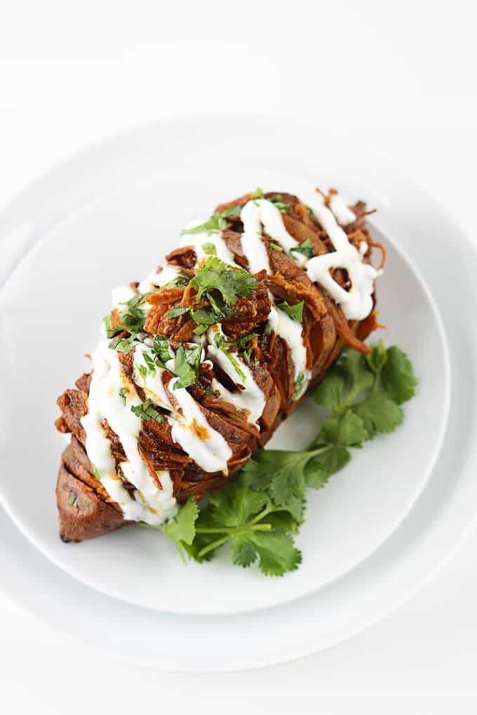 top view of a bbq pulled pork stuffed hasselback sweet potato.