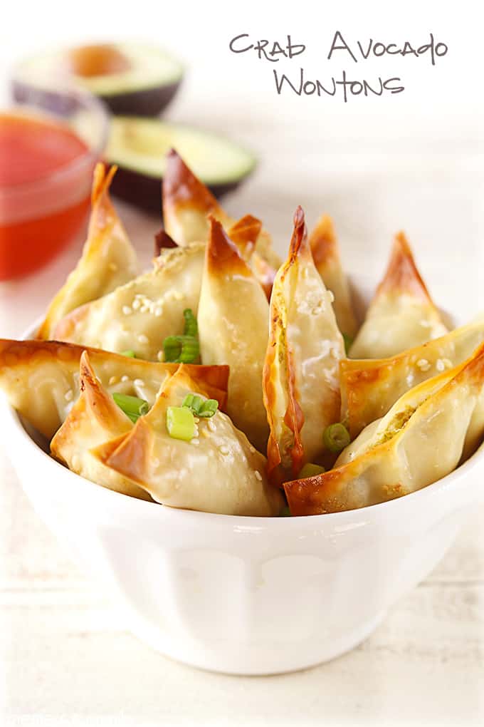 oven baked crab avocado wontons in a bowl with the title of the recipe written on the top right corner of the image.