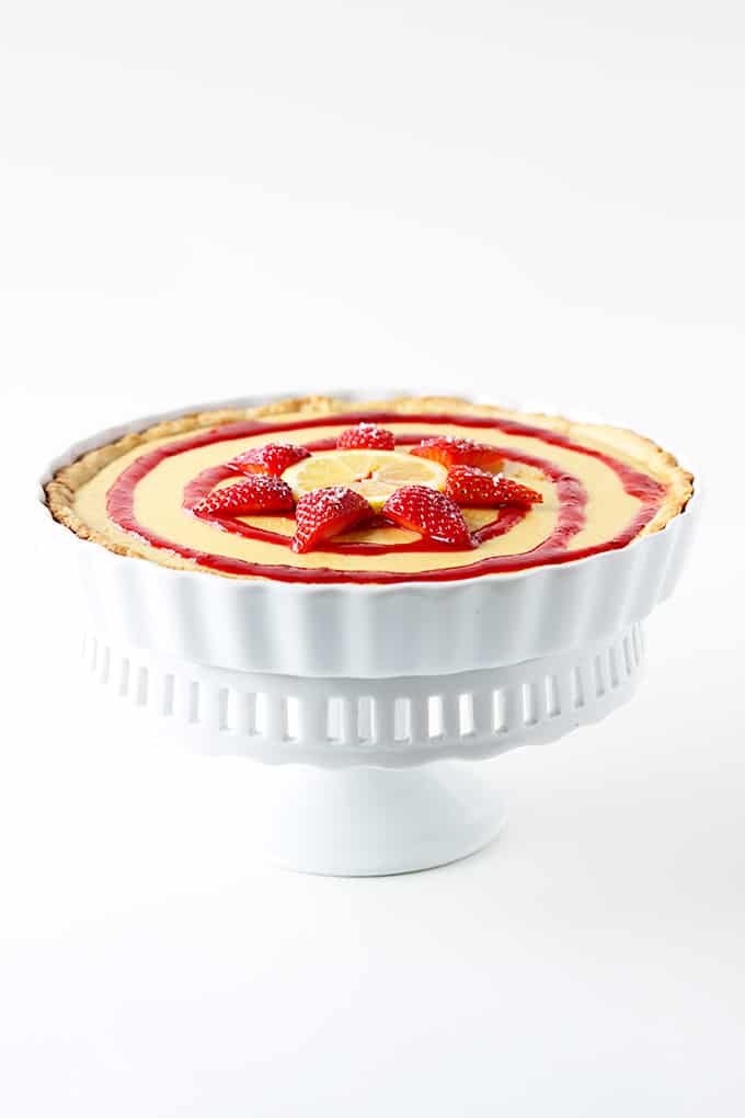honey lemon & strawberry tart in a pedestal dish.