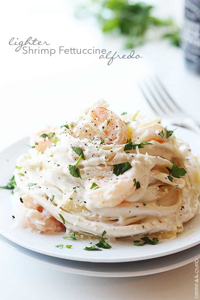shrimp fettuccine Alfredo on a plate with the title of the recipe written on the top left corner of the image.