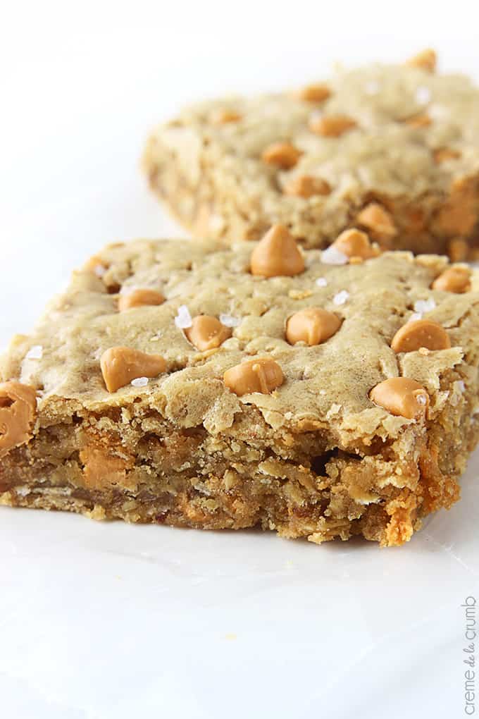 close up of a oatmeal butterscotch blondie with another blondie faded in the background.