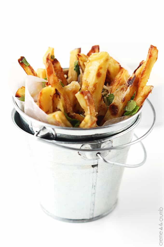 garlic parmesan oven fries in a small metal bucket.