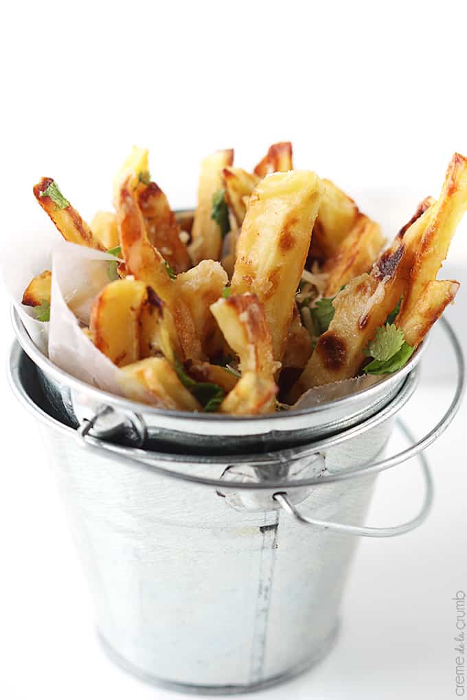 close up of garlic parmesan oven fries in a small metal bucket.