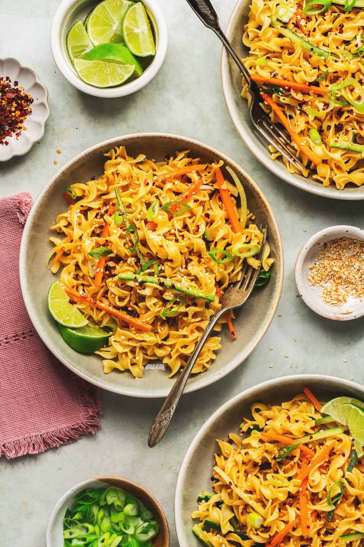 Overhead of bowls of sesame noodles.