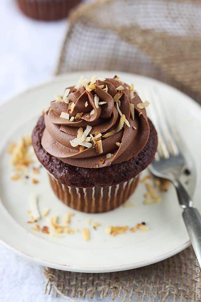 a chocolate coconut cupcake on a plate with a fork.