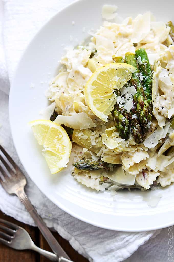 top view of lemon artichoke & asparagus pasta on a plate with two forks on the side.