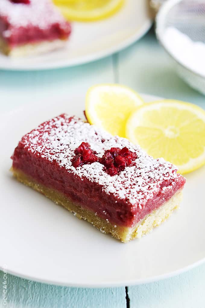 close up of a raspberry lemonade bar with slices of lemon on a plate.