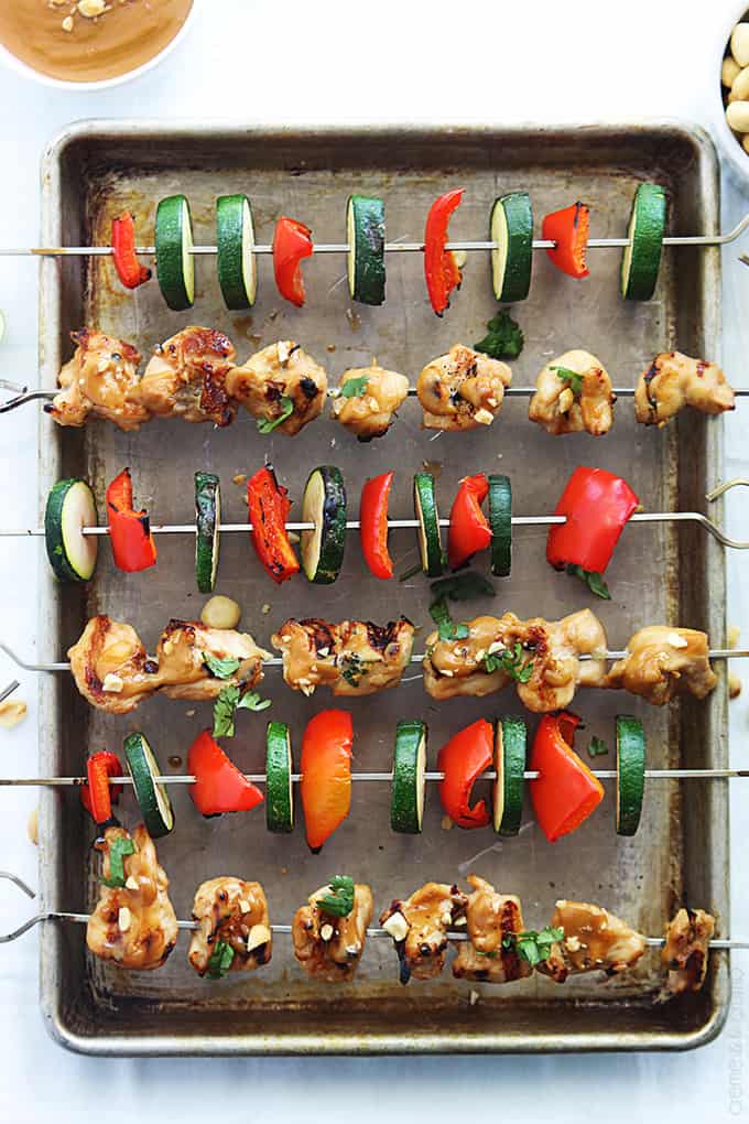 top view of Thai peanut chicken kabobs on a baking sheet.