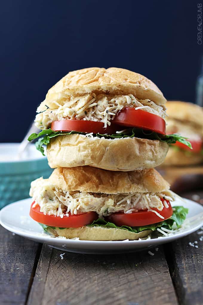 two stacked slow cooker chicken caesar sliders on a plate.