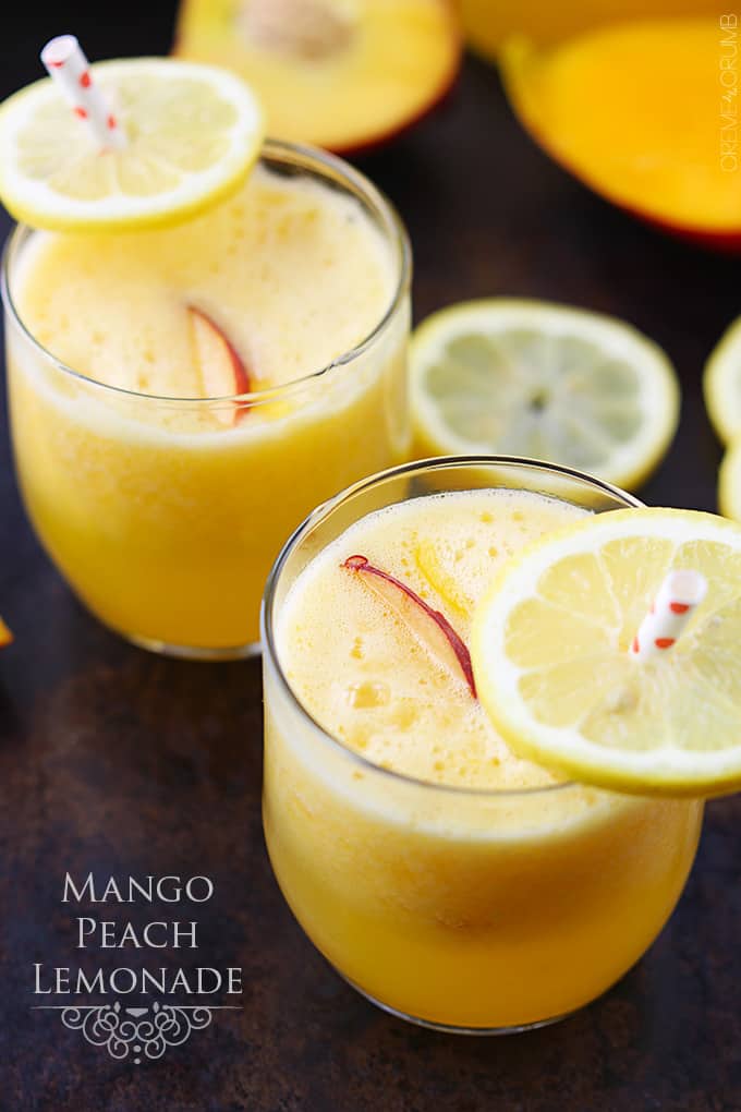 a couple of glasses of mango peach lemonade with lemon slices on the straws and the title of the recipe written on the bottom left corner of the image.