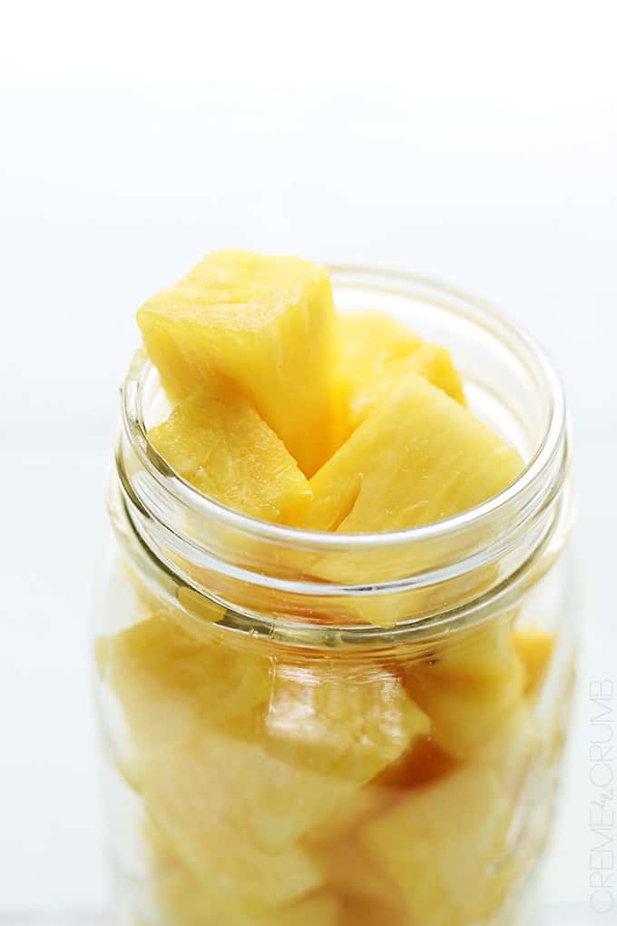 a mason jar full of pineapples chunks.