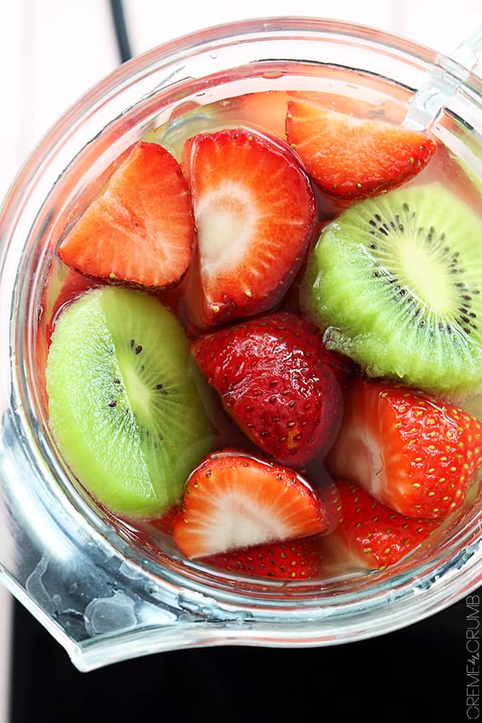 top view of lemonade, strawberries and kiwi slices in a blender.