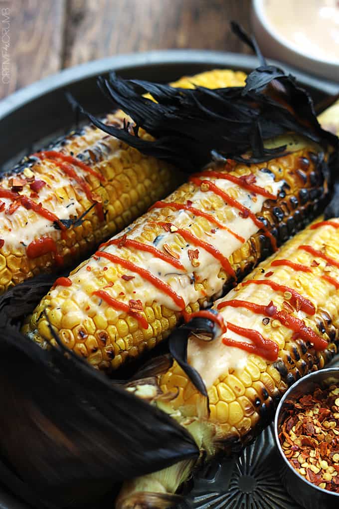 close up of Asian grilled corn on a serving tray.