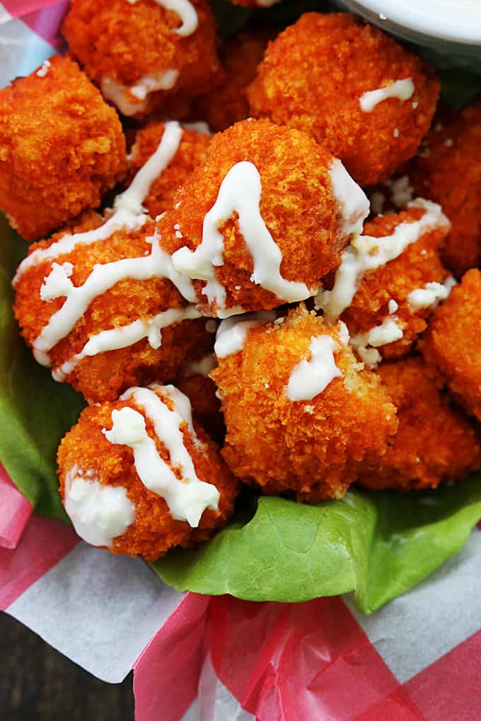 close up of buffalo popcorn chicken with sauce on top.