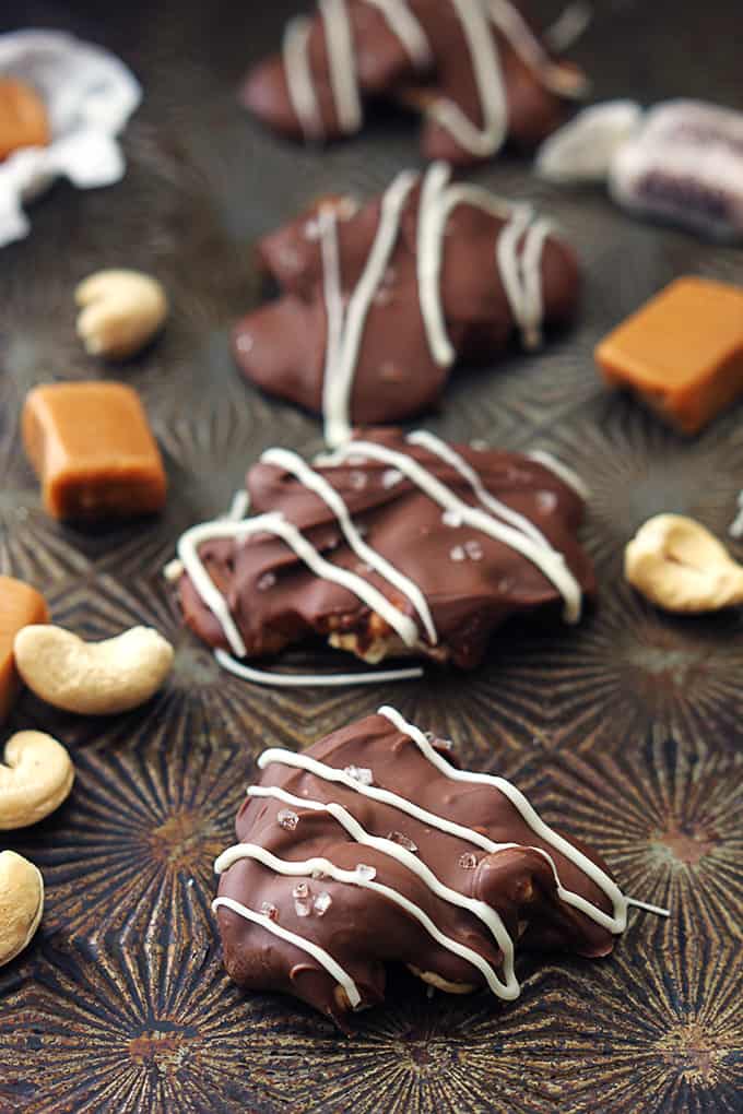 caramel cashew clusters with pieces of caramel and cashews around them.
