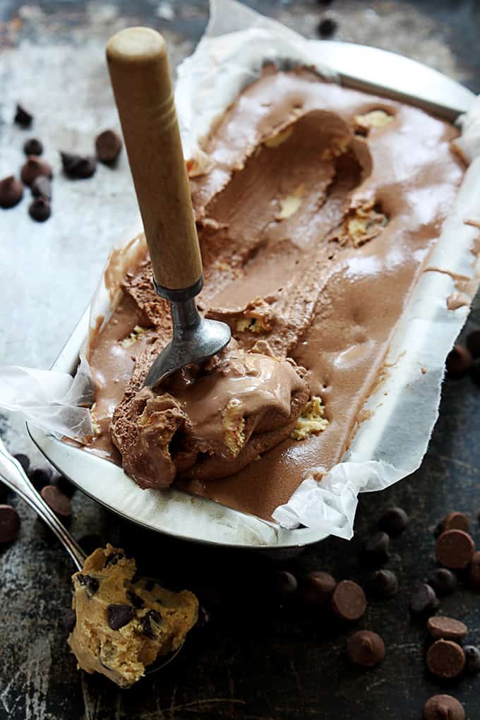 chocolate cookie dough ice cream in a tray with an ice cream scooper.