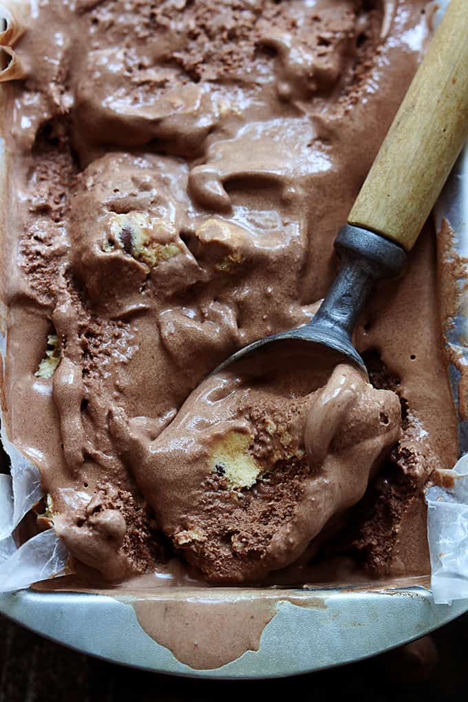 top view of chocolate cookie dough ice cream in a tray with an ice cream scooper.