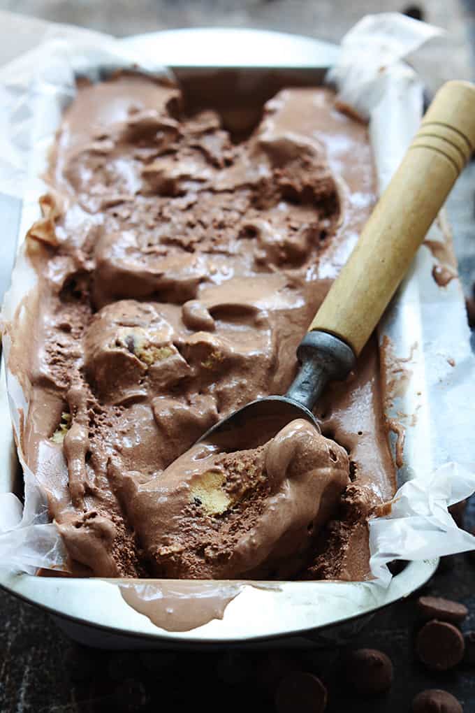 chocolate cookie dough ice cream in a tray with an ice cream scooper.