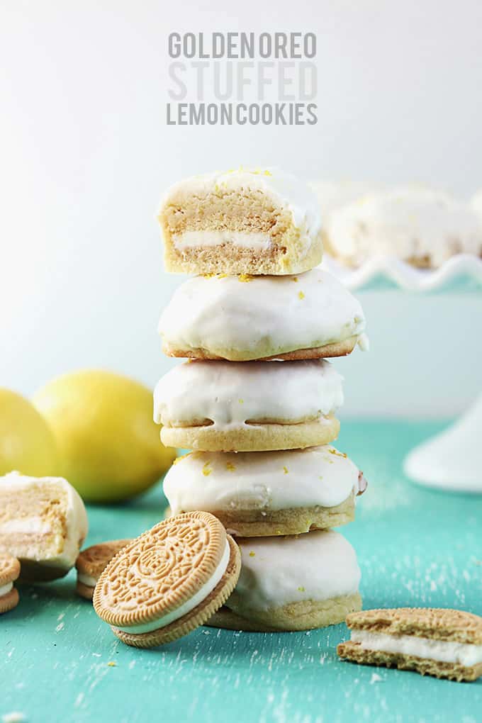 stacked golden Oreo stuffed lemon cookies with half of a cookie on the top with the title of the recipe written on the top middle of the image.
